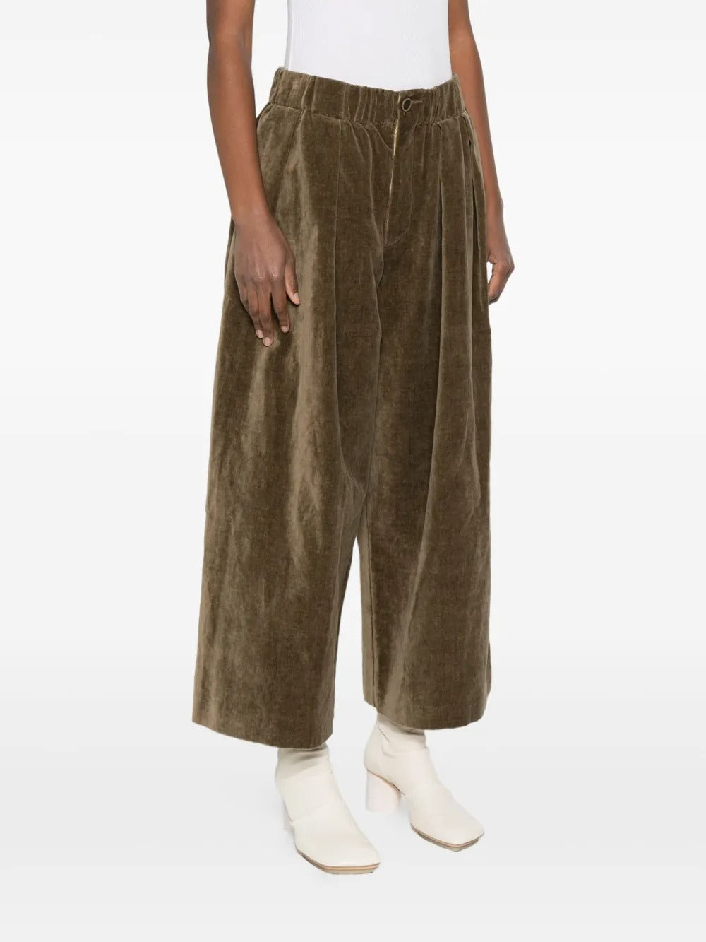 Brown pant worn by a person, showing the pant's fit