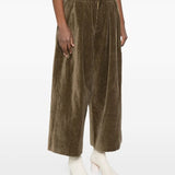 Brown pant worn by a person, showing the pant's fit