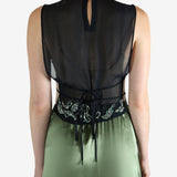 Green top worn by a person, showing the top fit