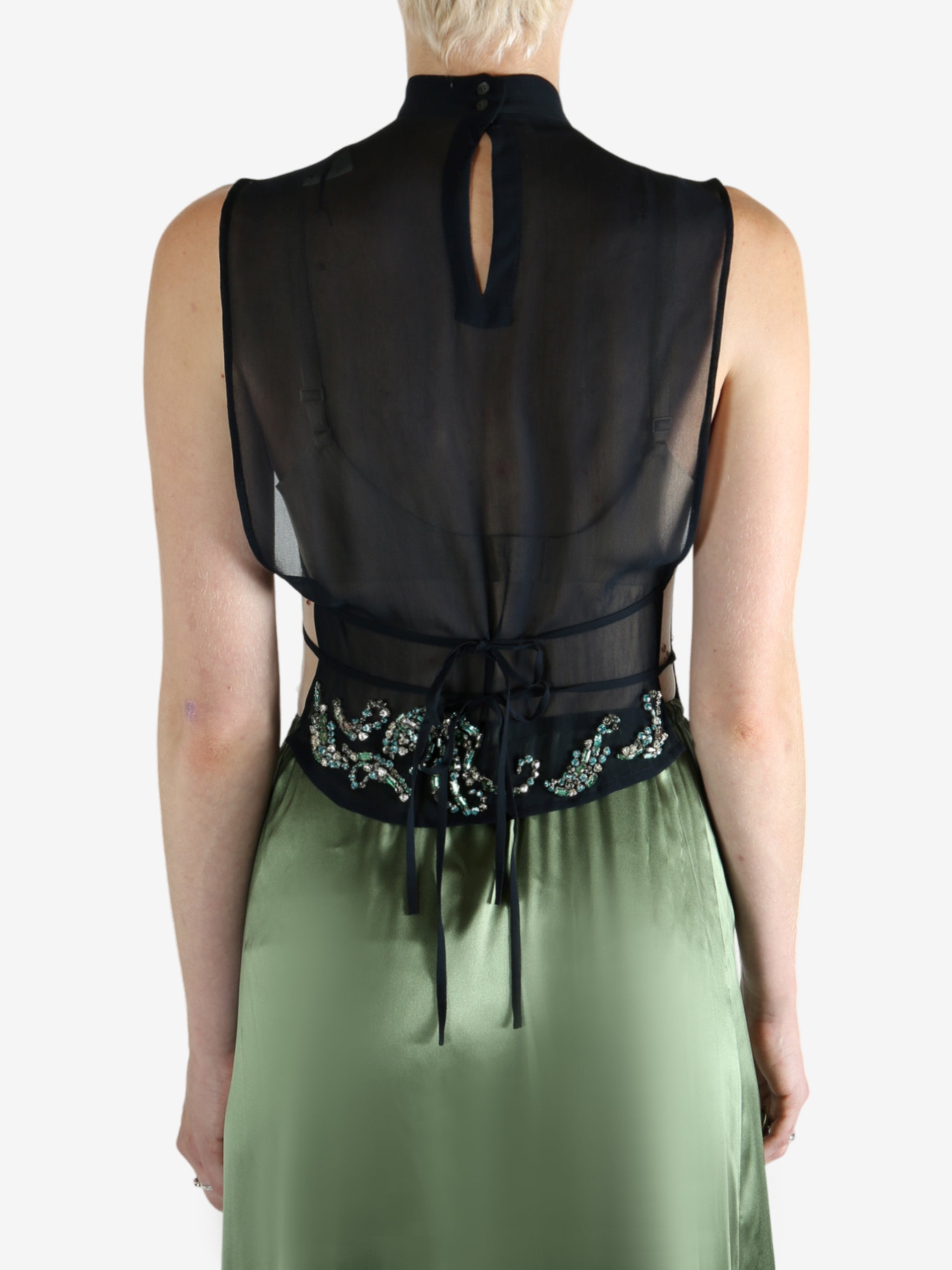 Green top worn by a person, showing the top fit