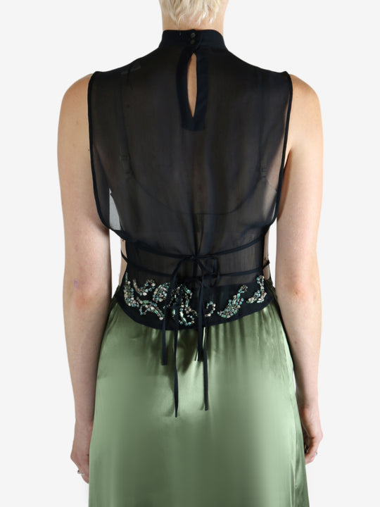 Green top worn by a person, showing the top fit