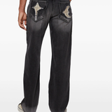 black jeans worn by a person, showing the jeans fit