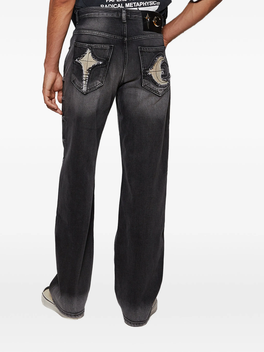 black jeans worn by a person, showing the jeans fit