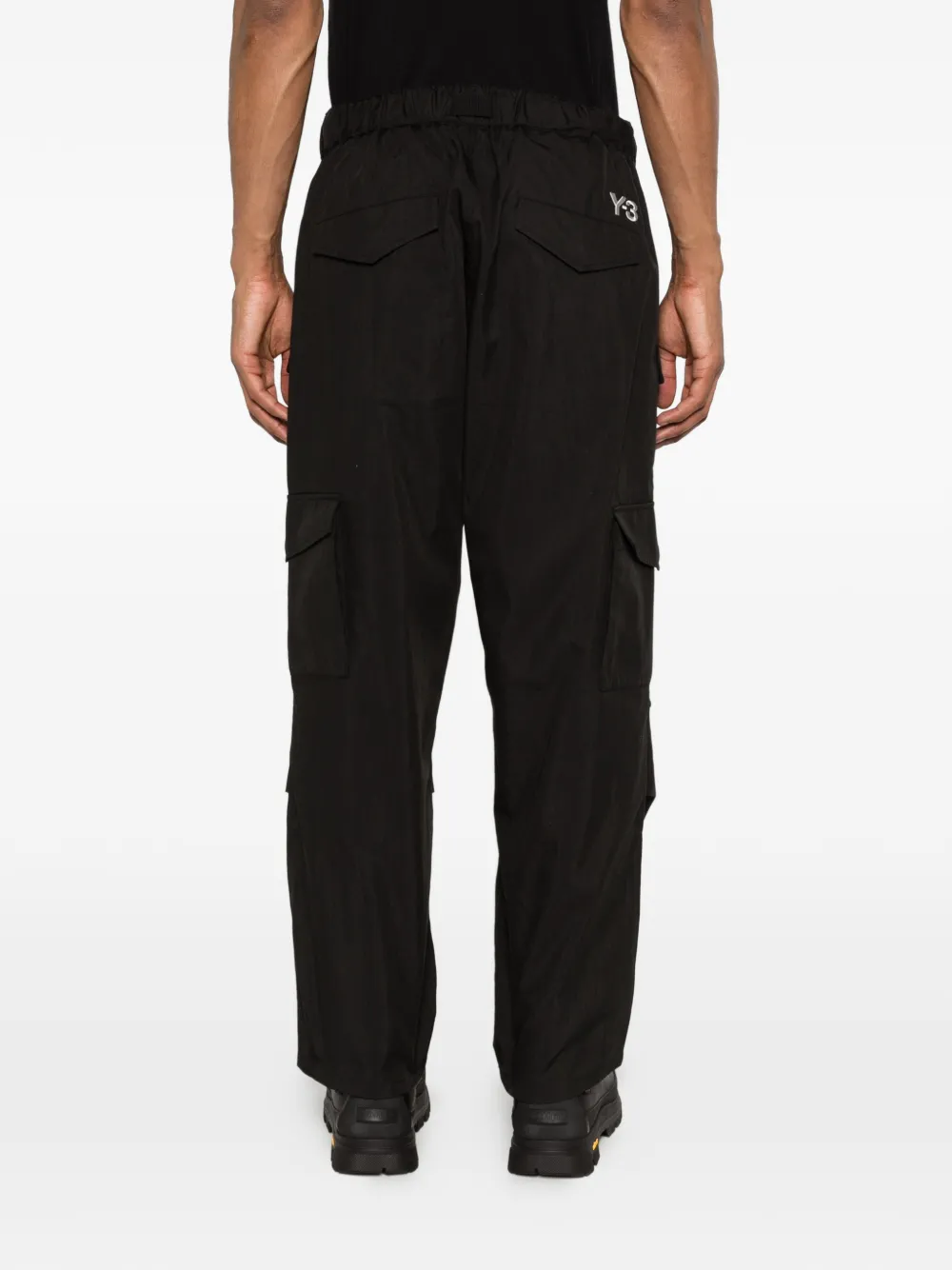 Black pant worn by a person, showing the pant's fit