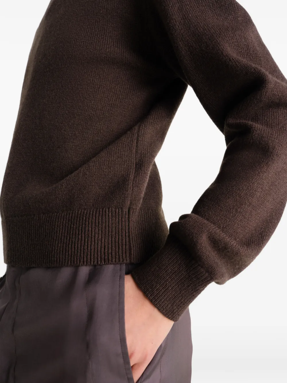 Close up of brown knitwear, showing texture of the wool fabric