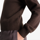 Close up of brown knitwear, showing texture of the wool fabric