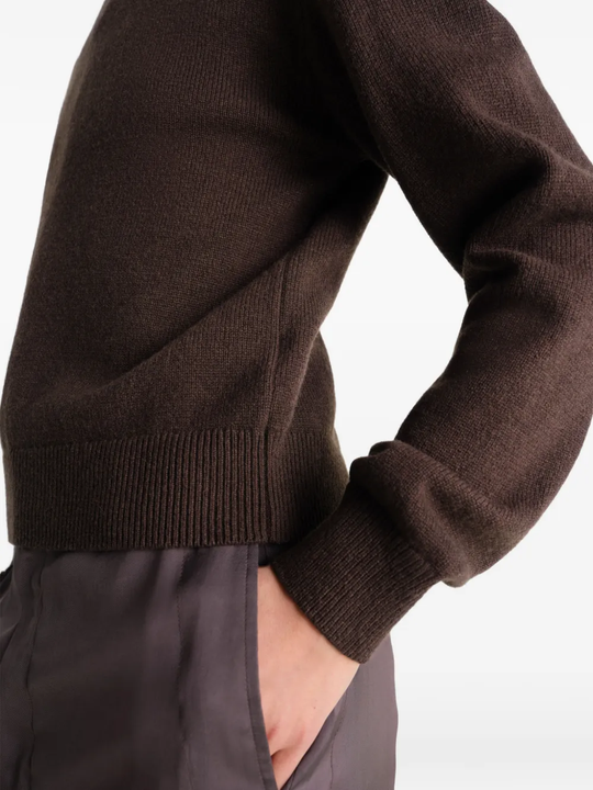 Close up of brown knitwear, showing texture of the wool fabric