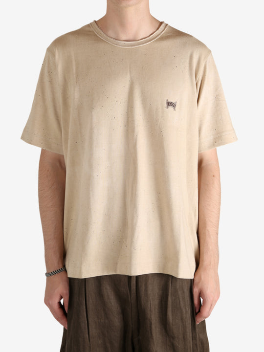 Tan t-shirt worn by a person, showing the t-shirt's fit