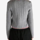 Grey knitwear worn by a person, showing the knitwear's fit
