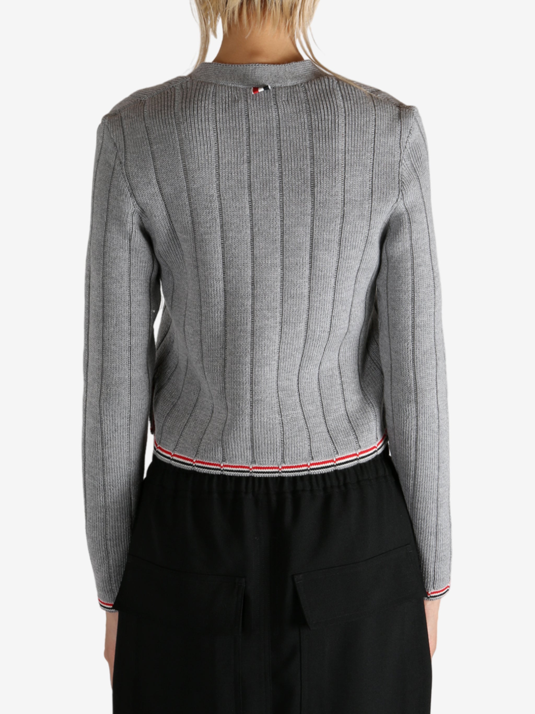 Grey knitwear worn by a person, showing the knitwear's fit