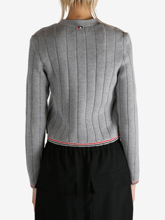 Grey knitwear worn by a person, showing the knitwear's fit