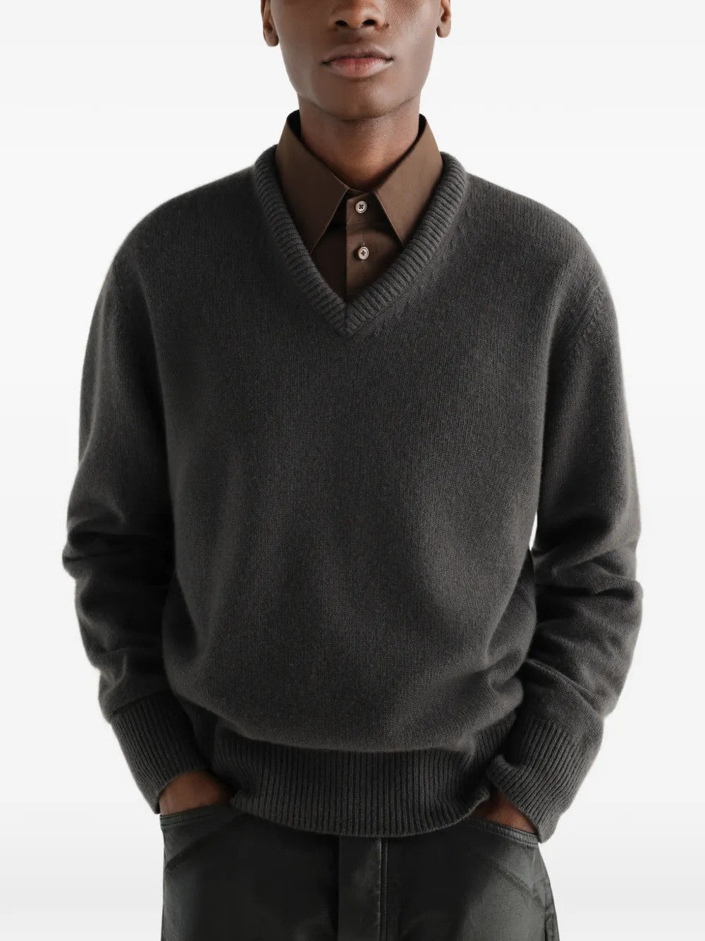 Grey knitwear worn by a person, showing the knitwear fit
