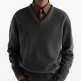 Grey knitwear worn by a person, showing the knitwear fit