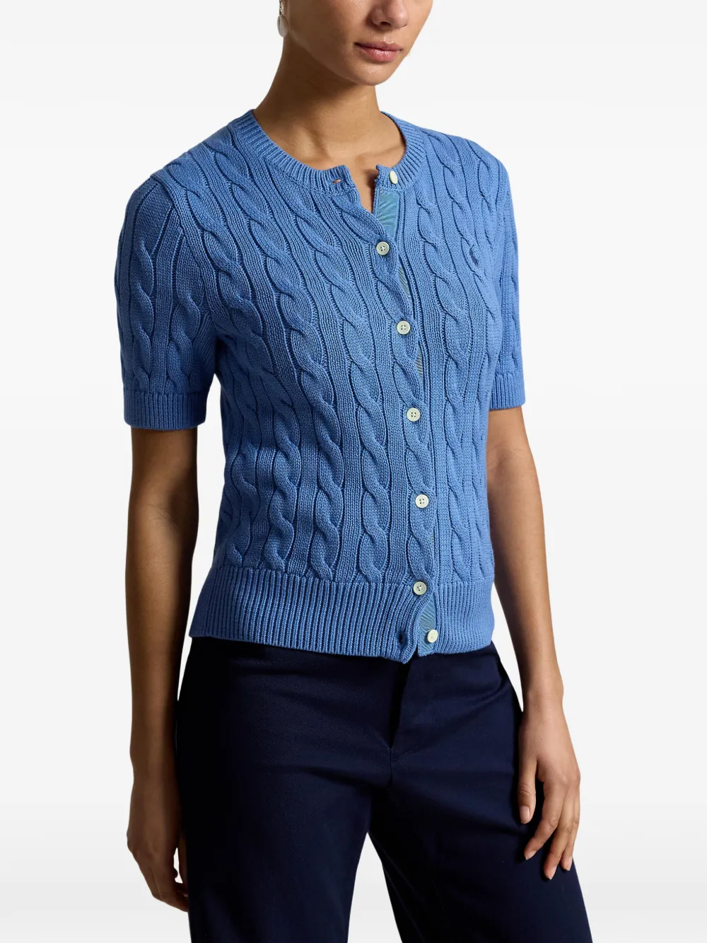 Blue knitwear worn by a person, showing the knitwear fit