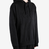Black hoodie worn by a person, showing the hoodie fit
