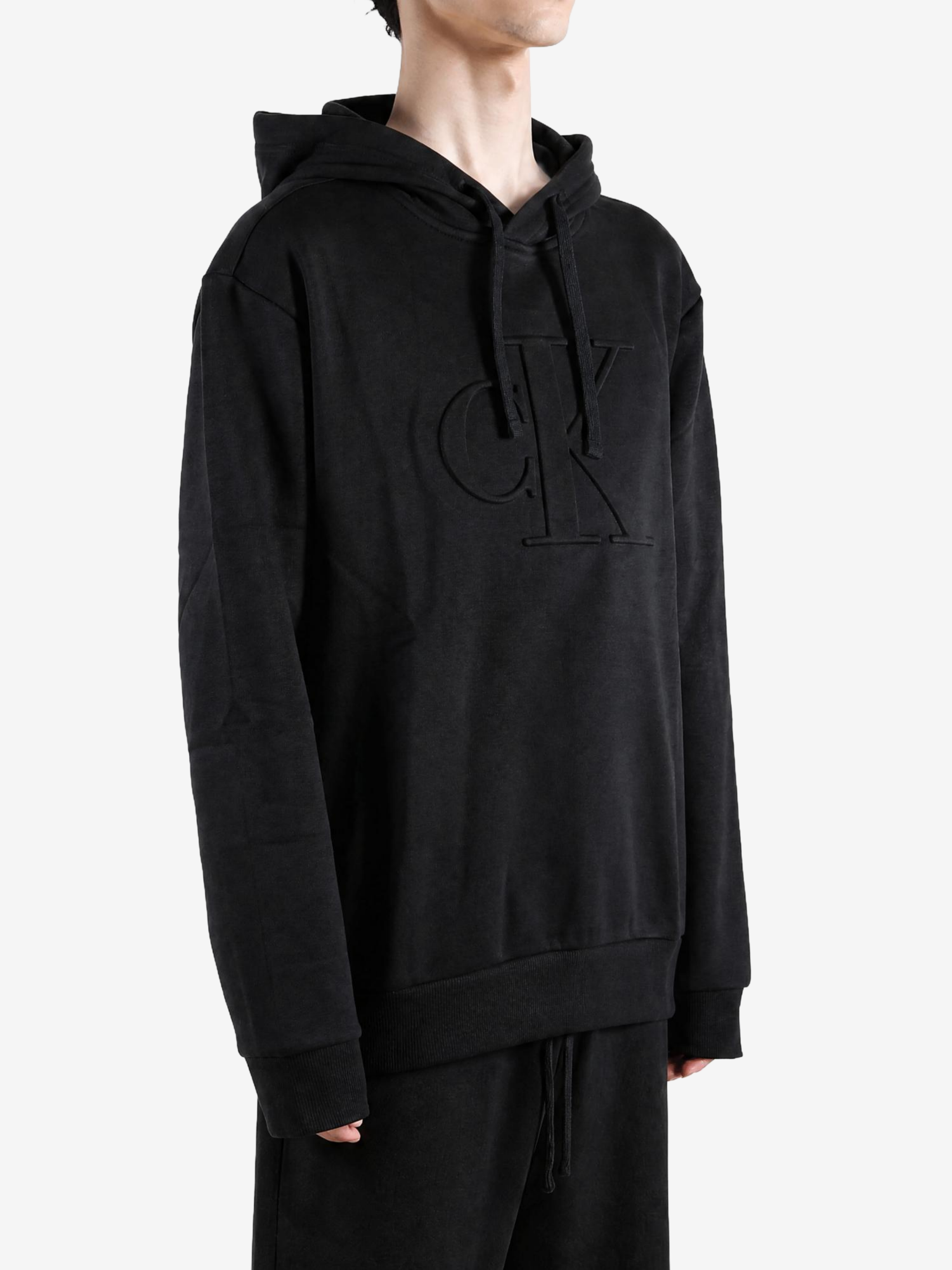 Black hoodie worn by a person, showing the hoodie fit