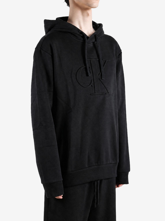 Black hoodie worn by a person, showing the hoodie fit