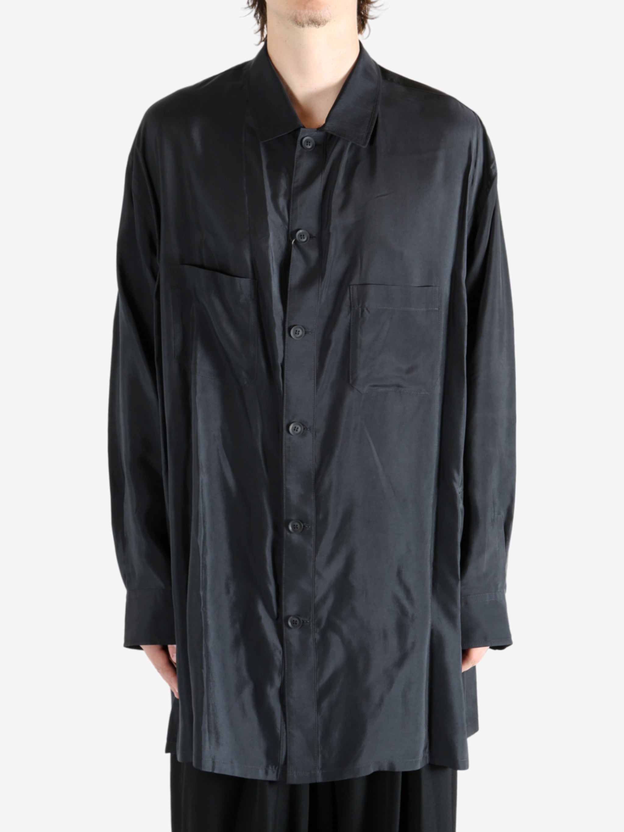 Black shirt worn by a person, showing the shirt's fit