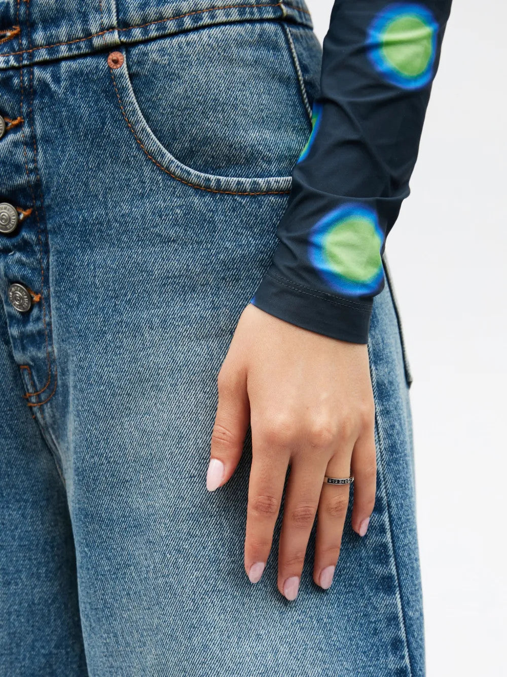 Grey jewelry worn by a person, showing the jewelry fit