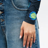 Grey jewelry worn by a person, showing the jewelry fit