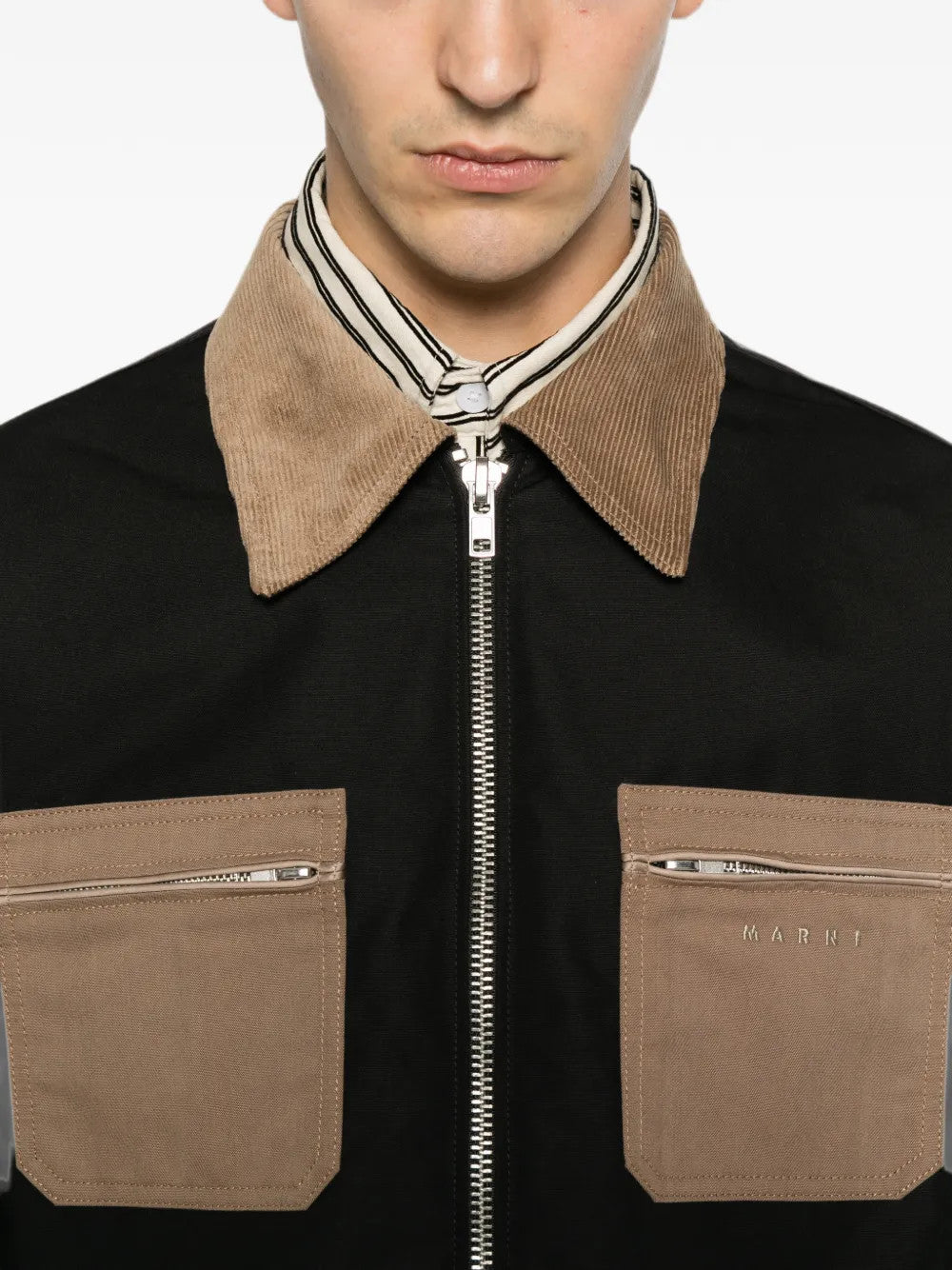 Black jacket worn by a person, showing the jacket fit