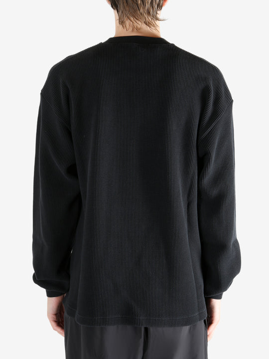 Black t-shirt worn by a person, showing the t-shirt's fit