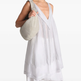 White bag worn by a person, showing the bag's fit