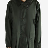 Green jacket worn by a person, showing the jacket's fit