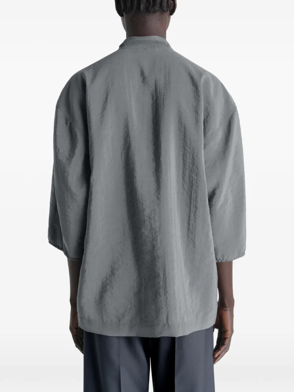 Grey top worn by a person, showing the top's fit