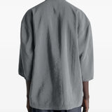 Grey top worn by a person, showing the top's fit