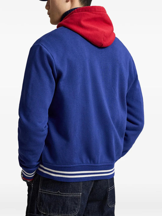 Blue jacket worn by a person, showing the jacket fit