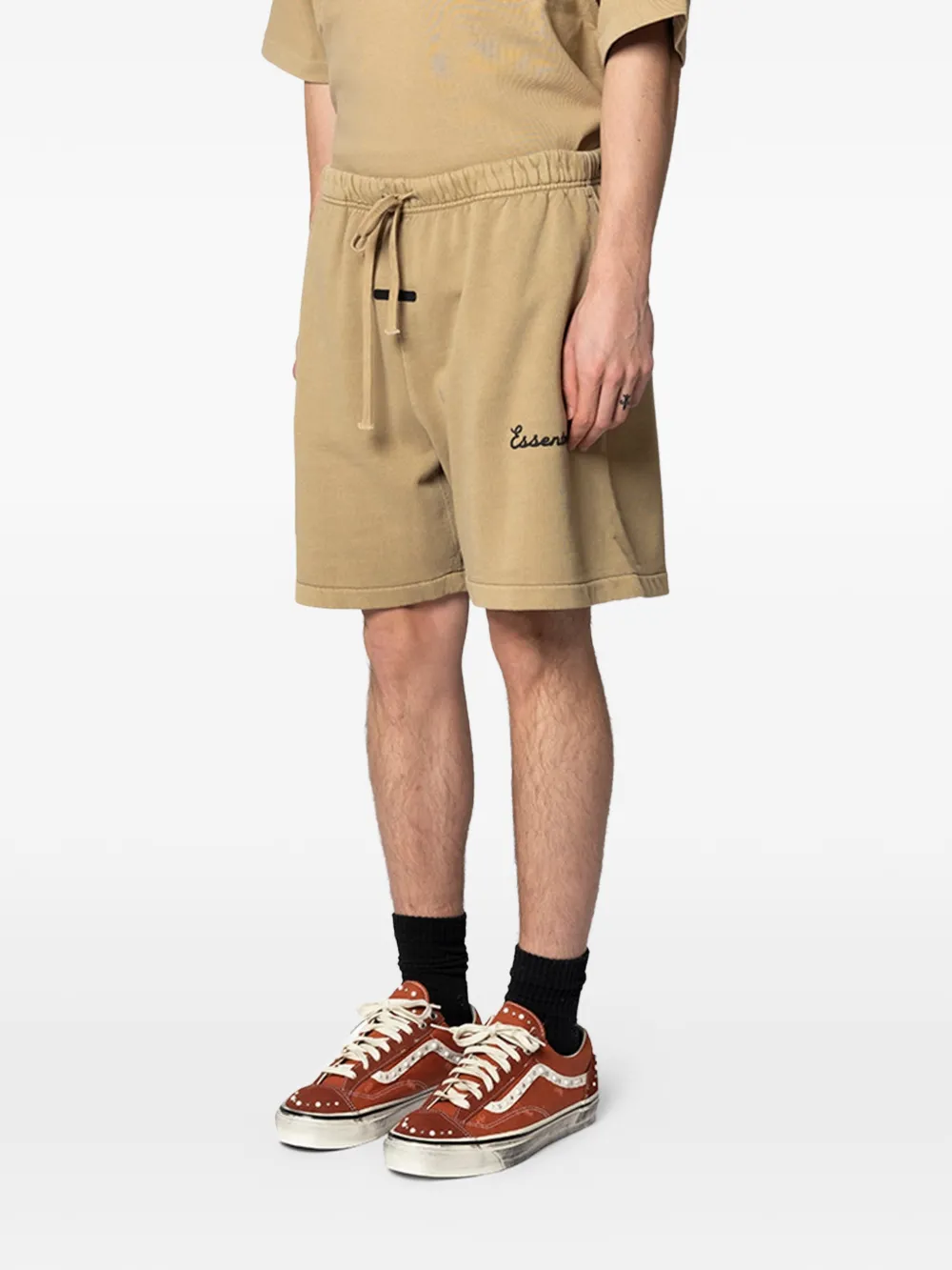 Tan shorts worn by a person, showing the shorts's fit
