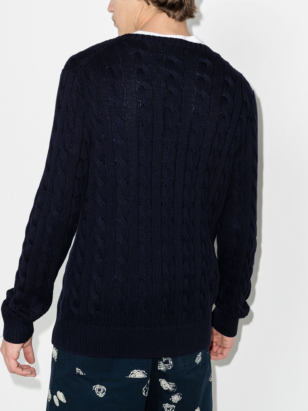 Navy pullover worn by a person, showing the pullover's fit