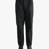 Black pants worn by a person, showing the pants' fit