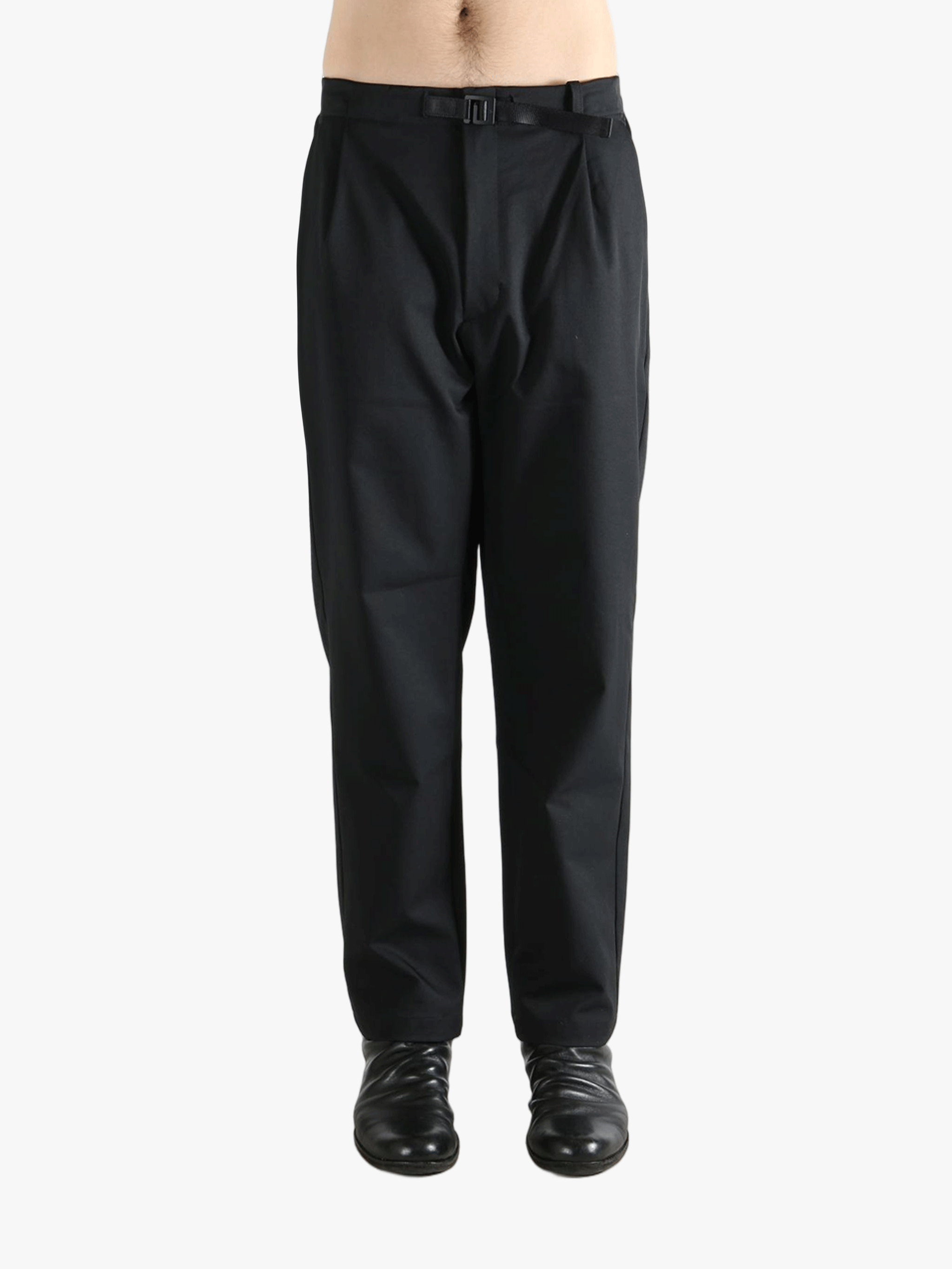 Black pants worn by a person, showing the pants' fit