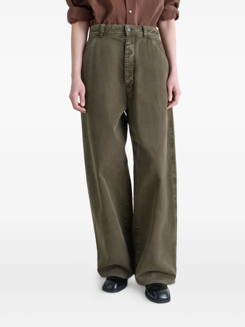 Brown pants worn by a person, showing the pants fit