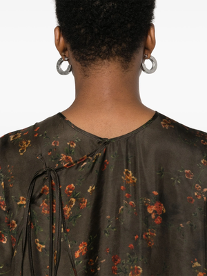 Close up of brown floral dress, showing texture of the viscose fabric