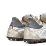 Close up of grey sneakers, showing texture of the leather fabric