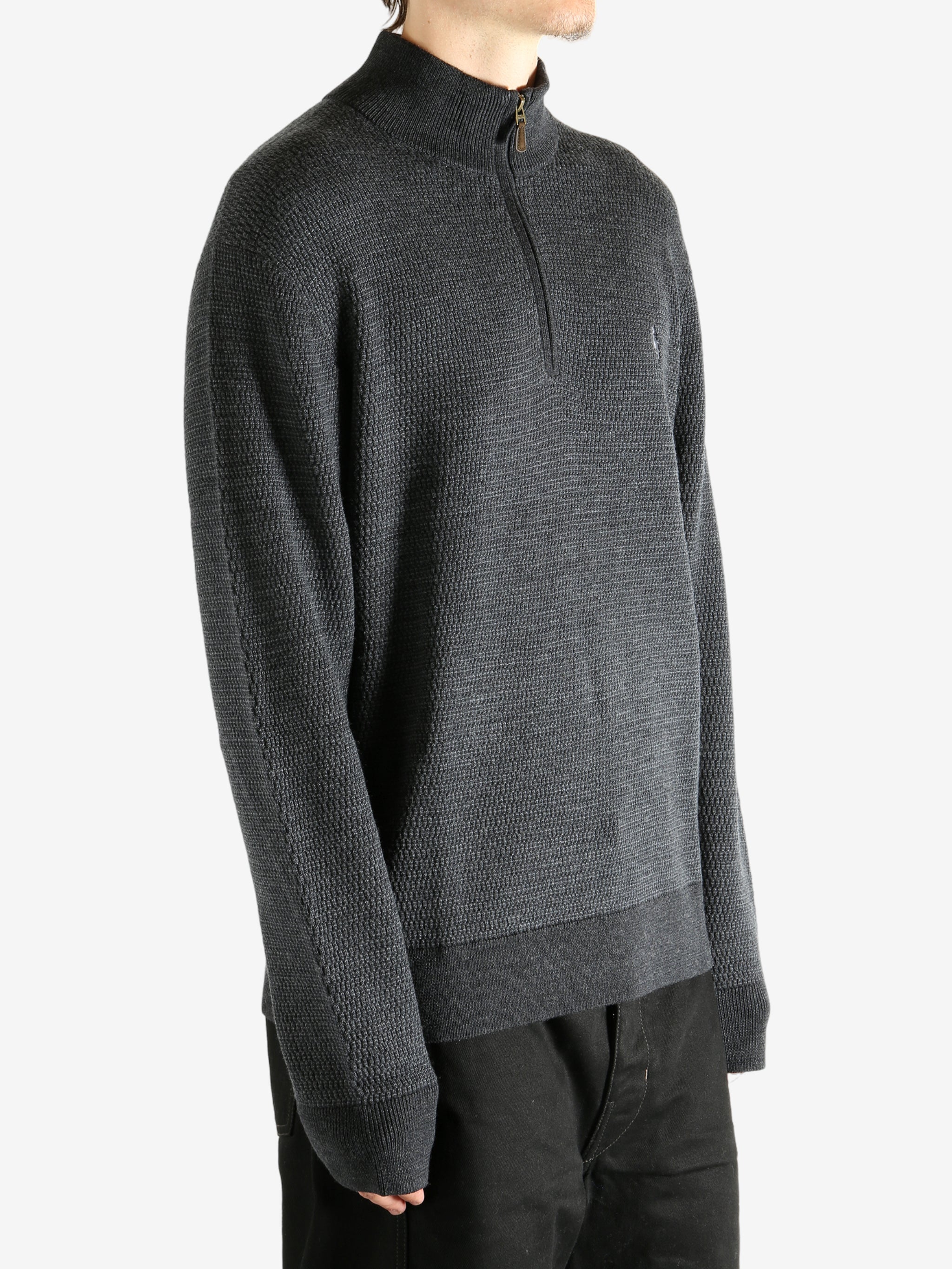 Grey knitwear worn by a person, showing the knitwear's fit