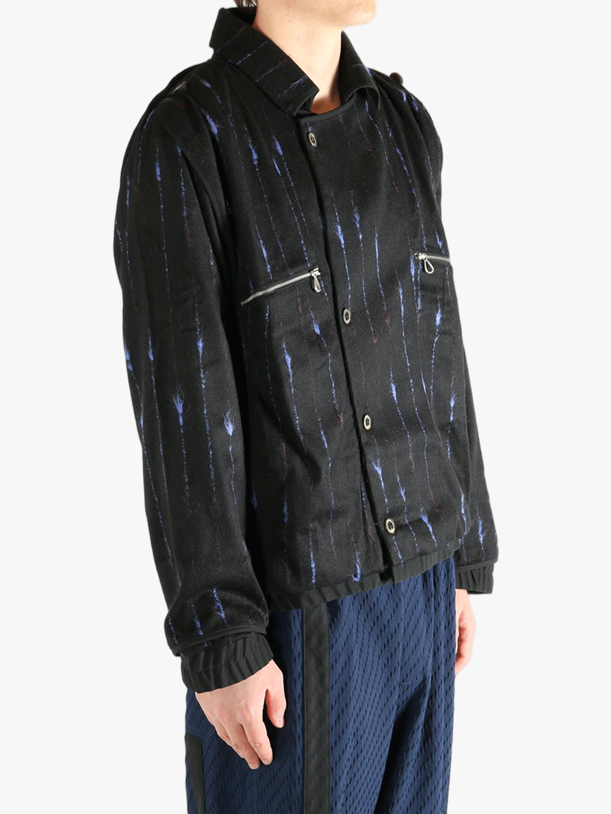 Black jacket worn by a person, showing the jacket's fit