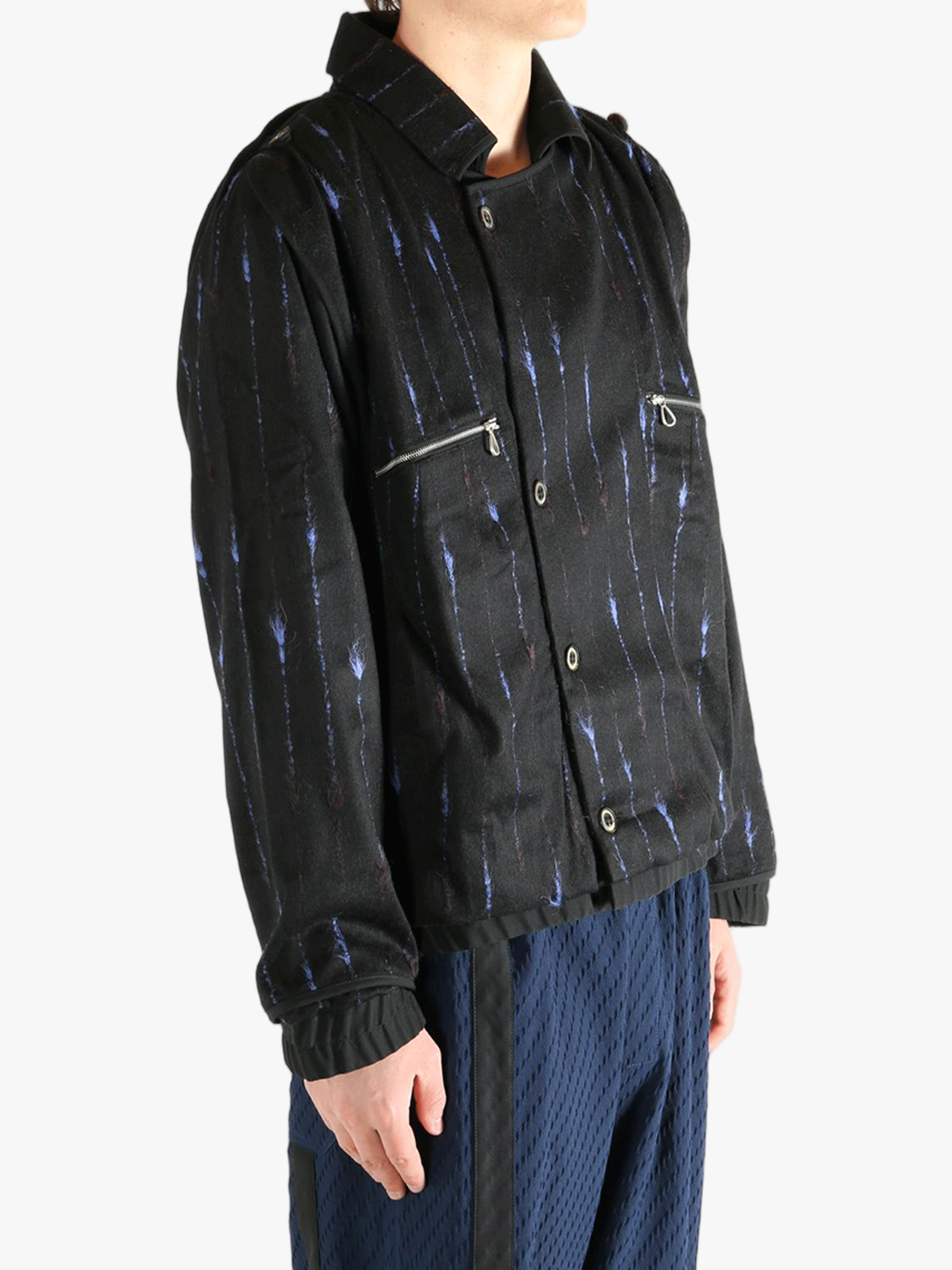 Black jacket worn by a person, showing the jacket's fit