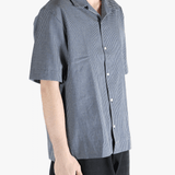 Blue checkered shirt worn by a person, showing the shirt's fit