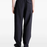 Black pants worn by a person, showing the pants' fit