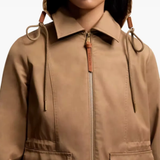 Close up of brown jackets-coats, showing texture of the polyester fabric