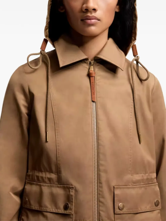 Close up of brown jackets-coats, showing texture of the polyester fabric