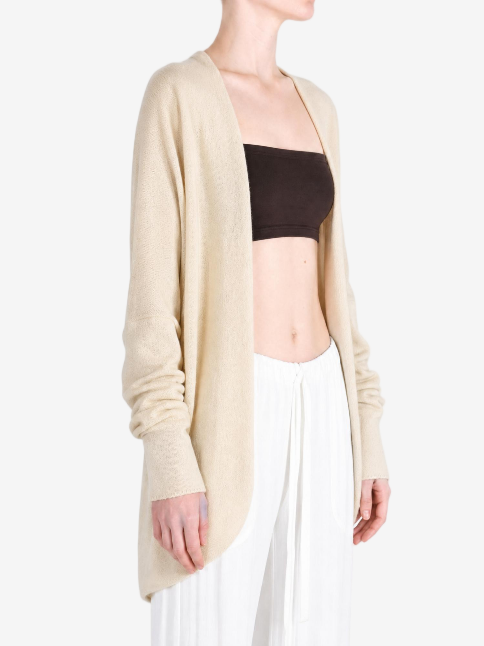 Tan knitwear worn by a person, showing the knitwear fit