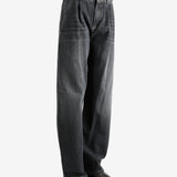 Black jeans worn by a person, showing the jean's fit