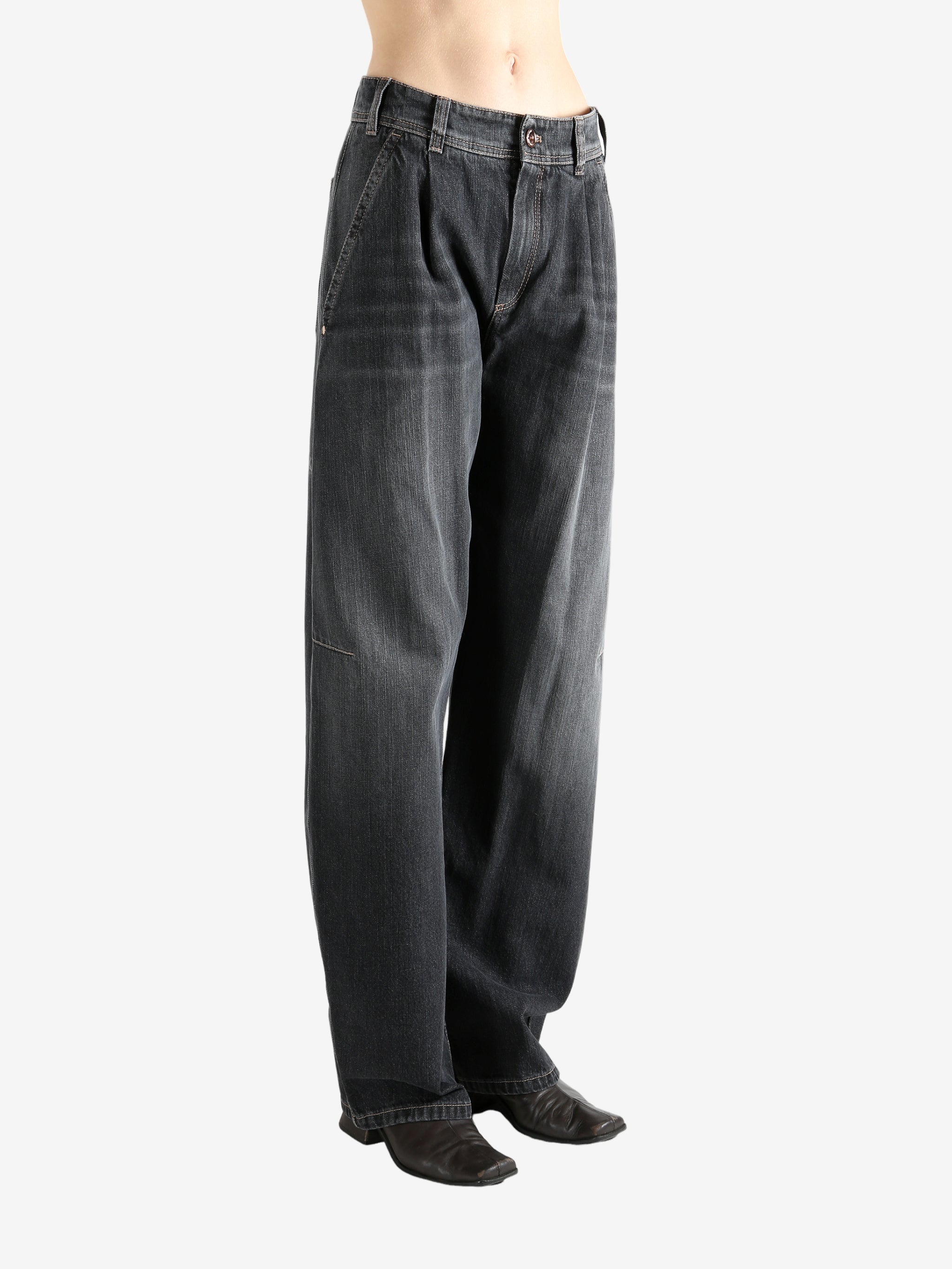 Black jeans worn by a person, showing the jean's fit