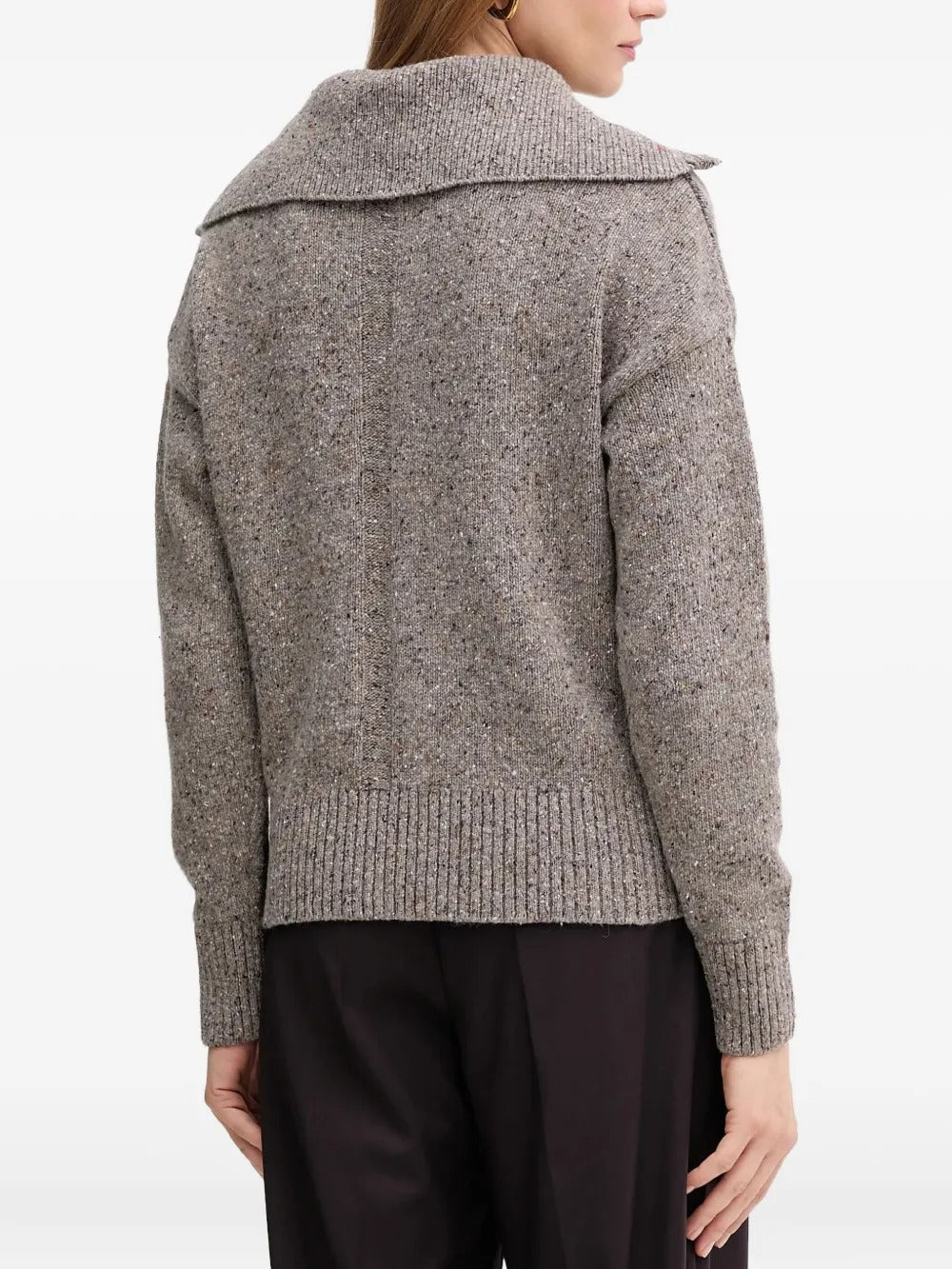 Grey knitwear worn by a person, showing the knitwear's fit