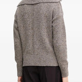 Grey knitwear worn by a person, showing the knitwear's fit